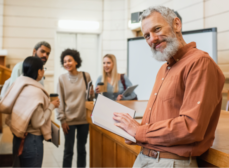 Faculty smiling with students in the background